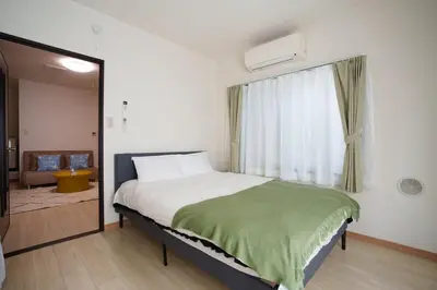 a bedroom with a large bed and a window at Asakusa\u5f92\u6b692\u5206 MAX5\u540d Asakusa\u99c5\u304b\u3089\u5f92\u6b696\u5206 in Tokyo
