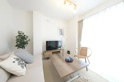 a living room with a couch and a tv at Cozy Nest Nakano 2 stops 5 min to Ikebukuro 7 stops to Shinjuku 15 min new 1LDK in Tokyo