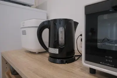a coffee pot sitting on a counter next to a microwave at Cozy Nest Nakano 2 stops 5 min to Ikebukuro 7 stops to Shinjuku 15 min new 1LDK in Tokyo
