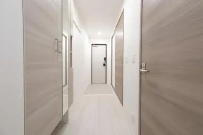 a hallway with a door leading to a hallway with white walls at Cozy Nest Nakano 2 stops 5 min to Ikebukuro 7 stops to Shinjuku 15 min new 1LDK in Tokyo