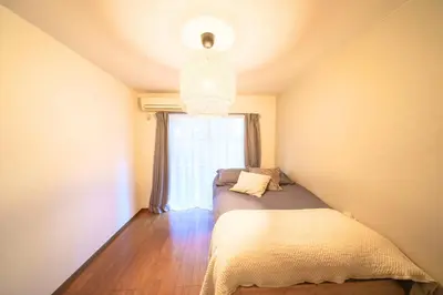 a small bedroom with a bed and a window at Premier suite Shinjuku okubo Tokyo 1F 2F in Tokyo