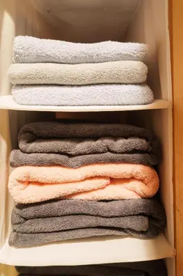 a stack of towels in a closet at Premier suite Shinjuku okubo Tokyo 1F 2F in Tokyo