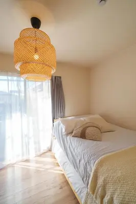 a bedroom with a bed and a large window at Premier suite Shinjuku okubo Tokyo 1F 2F in Tokyo