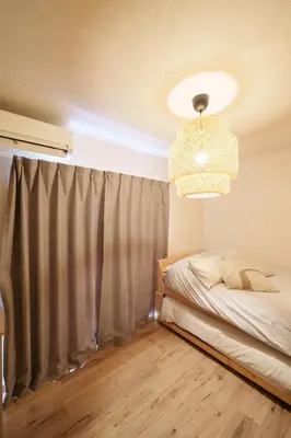 a bedroom with a bed and a chandelier at Premier suite Shinjuku okubo Tokyo 1F 2F in Tokyo