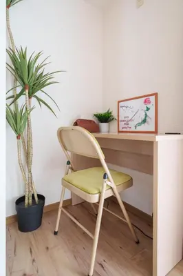a chair in front of a desk with plants at Premier suite Shinjuku okubo Tokyo 1F 2F in Tokyo
