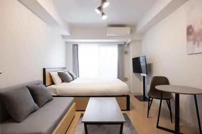 a living room with a bed and a couch at \u30ec\u30b8\u30c7\u30a3\u30a2\u4e2d\u843d\u5408b in Tokyo