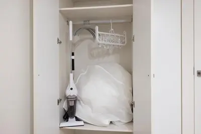 a room with a white closet with a white pillow at \u30ec\u30b8\u30c7\u30a3\u30a2\u4e2d\u843d\u5408b in Tokyo