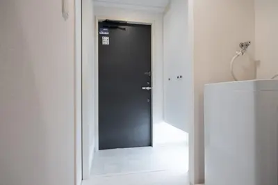 a black door in a room with a white floor at \u30ec\u30b8\u30c7\u30a3\u30a2\u4e2d\u843d\u5408b in Tokyo