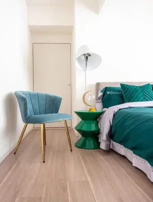 a bedroom with a bed and a blue chair at \u4e0a\u91ce402 MAX 8 \u9280\u5ea7Asakusa\u30a8\u30ea\u30a2Wi - Fi in Tokyo
