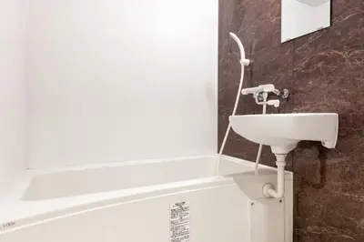 a bathroom with a sink and a bath tub at \u4e0a\u91ce402 MAX 8 \u9280\u5ea7Asakusa\u30a8\u30ea\u30a2Wi - Fi in Tokyo