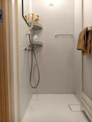 a bathroom with a shower and a sink at Issyuku Hotel Kotobuki Sanchome in Tokyo
