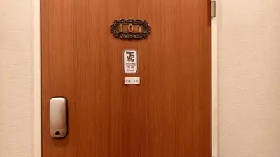 a wooden door with a sign on it at Issyuku Hotel Kotobuki Sanchome in Tokyo