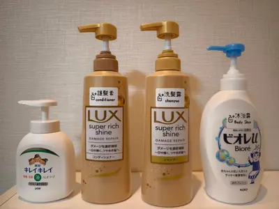 a group of four bottles of cleaning products on a counter at Issyuku Hotel Kotobuki Sanchome in Tokyo