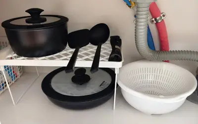 a kitchen counter with utensils on a shelf at Issyuku Hotel Kotobuki Sanchome in Tokyo