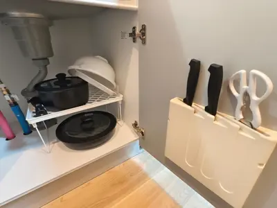 a kitchen with a shelf with cooking utensils at Issyuku Hotel Kotobuki Sanchome in Tokyo