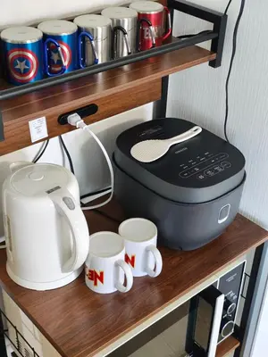 a shelf with a coffee maker and cups on it at YKO Guest house in Akihabara 60 square meters, 3 bedrooms, 1 living rooms elevator, sky tree view in Tokyo