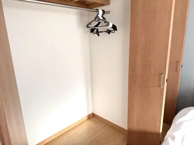 a bedroom with a bed and a lamp on the wall at \u6effJR Soubusen Hirai 5mins walk Guest house! 2LDK,Max 8PP! Direct access to Kinshicyo,Akihabara,Shinjyuku! in Tokyo
