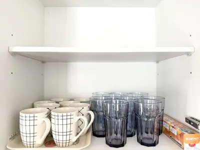 a row of glass cups sitting on a shelf at \u6effJR Soubusen Hirai 5mins walk Guest house! 2LDK,Max 8PP! Direct access to Kinshicyo,Akihabara,Shinjyuku! in Tokyo