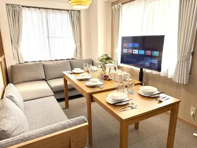 a living room with a table and a tv at \u6effJR Soubusen Hirai 5mins walk Guest house! 2LDK,Max 8PP! Direct access to Kinshicyo,Akihabara,Shinjyuku! in Tokyo