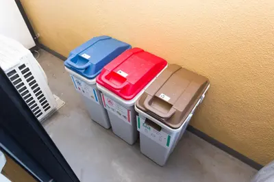four containers sitting against a wall next to a wall at Shinjuku sprem in Tokyo