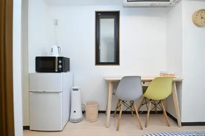 a kitchen with a table and two chairs at Shinjuku sprem in Tokyo