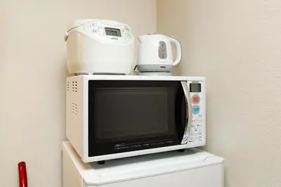 a white microwave with a blender on top of it at Shinjuku sprem in Tokyo