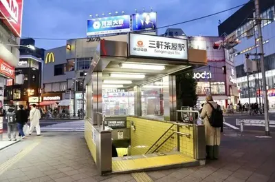 a woman standing in front of a store in a city at \u6b63\u6804\u30cf\u30a4\u30c4101 in Tokyo