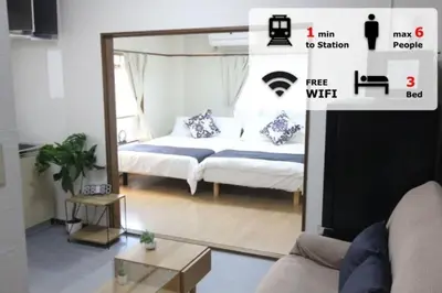 a living room with a bed and a mirror at Hotel LUANA in Shin-Nakano in Tokyo