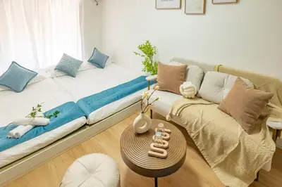 a living room with a couch and a table at 3-person mansion in Shinjuku Kabukicho train 8 mins in Tokyo