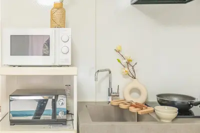 a kitchen counter with a microwave and a sink at 3-person mansion in Shinjuku Kabukicho train 8 mins in Tokyo