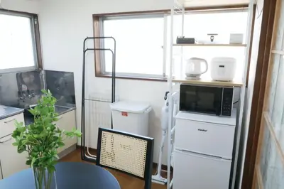 a small kitchen with a table and a refrigerator at \u6b63\u6804\u30cf\u30a4\u30c4201 in Tokyo