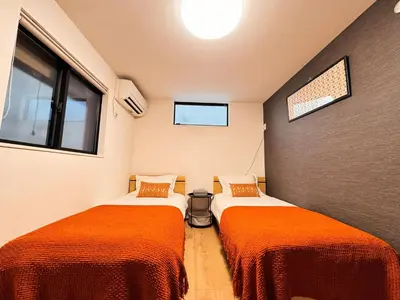 two beds in a small room with windows at Home Stroy in Tokyo - Luxury Villa Minowa&Ueno-三ノ輪一戸建て&東京屋語 in Tokyo