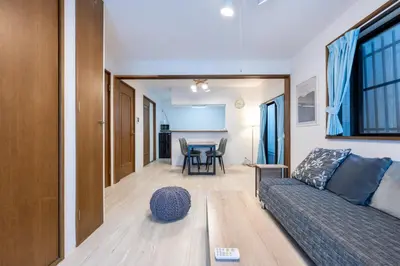 a living room with a couch and a table at FINOA Residential Suite Higashikanamachi in Tokyo