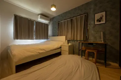 a bedroom with a bed and a desk and window at FINOA Residential Suite Higashikanamachi in Tokyo