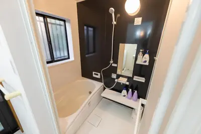 a bathroom with a bath tub and a sink at FINOA Residential Suite Higashikanamachi in Tokyo