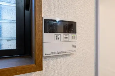 a wall with a microwave oven on a wall next to a window at FINOA Residential Suite Higashikanamachi in Tokyo