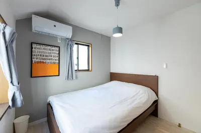 a bedroom with a bed and a window at FINOA Residential Suite Higashikanamachi in Tokyo