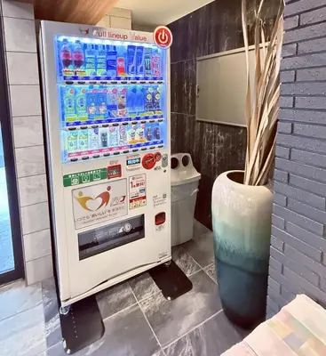 a vending machine with bottles of water in a bathroom at KINSHICHO Tokyo Holiday Hotel in Tokyo