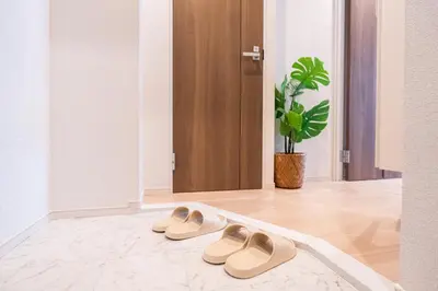 a pair of shoes sitting on a rug in a hallway at KINSHICHO Tokyo Holiday Hotel in Tokyo