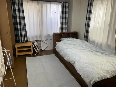 a bedroom with a bed in front of a window at Homestay at M's House Not entire property just one room in Tokyo