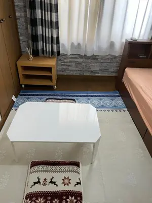 a living room with a white table and a bed at Homestay at M's House Not entire property just one room in Tokyo