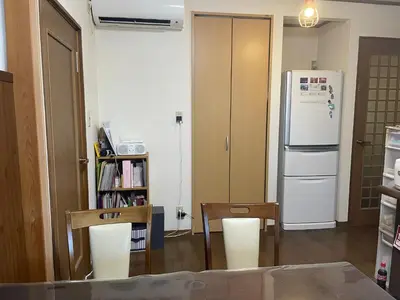 a kitchen with a refrigerator and a table and chairs at Homestay at M's House Not entire property just one room in Tokyo