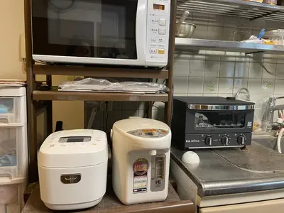 a kitchen with a microwave and other appliances on a counter at Homestay at M's House Not entire property just one room in Tokyo