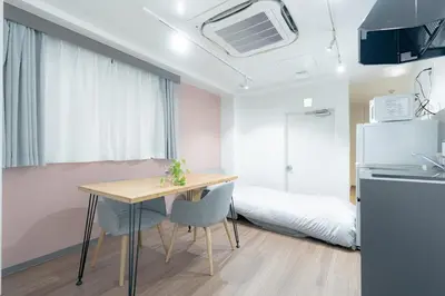 a kitchen and dining room with a table and a bed at unito residence TSUKIJI in Tokyo