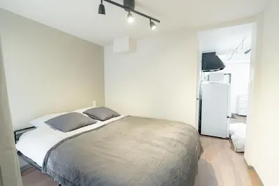 a bedroom with a large bed in a room at unito residence TSUKIJI in Tokyo