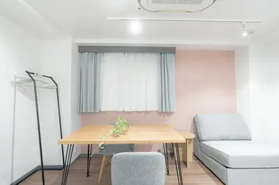 a small room with a table and a couch at unito residence TSUKIJI in Tokyo