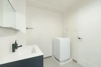 a white bathroom with a sink and a shower at unito residence TSUKIJI in Tokyo