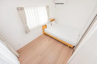 a small bedroom with a bed and a window at Japan House Skytree \u30f4\u30a3\u30e9\u8cb8\u5207 A\u9928 in Tokyo