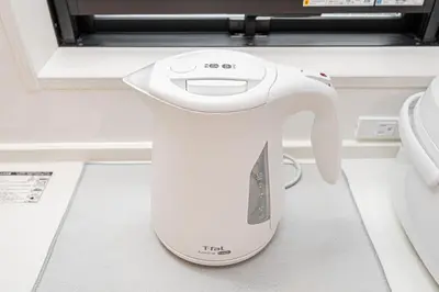 a white hair dryer sitting on the floor next to a toilet at Japan House Skytree \u30f4\u30a3\u30e9\u8cb8\u5207 A\u9928 in Tokyo