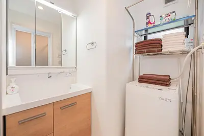 a bathroom with a sink and a washer and dryer at Japan House Skytree \u30f4\u30a3\u30e9\u8cb8\u5207 A\u9928 in Tokyo